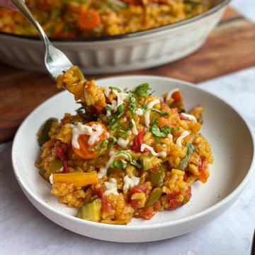 Spanish Vegetable Risotto: Healthy, beautiful rice dish from the coast of Mediterranean Sea loaded with fiber and protein. Creamy Arborio rice, green beans, onion, garlic, carrots, zucchini,  and tomatoes simmered in a savory vegetable broth makes a simple colorful delicious one pot meal.